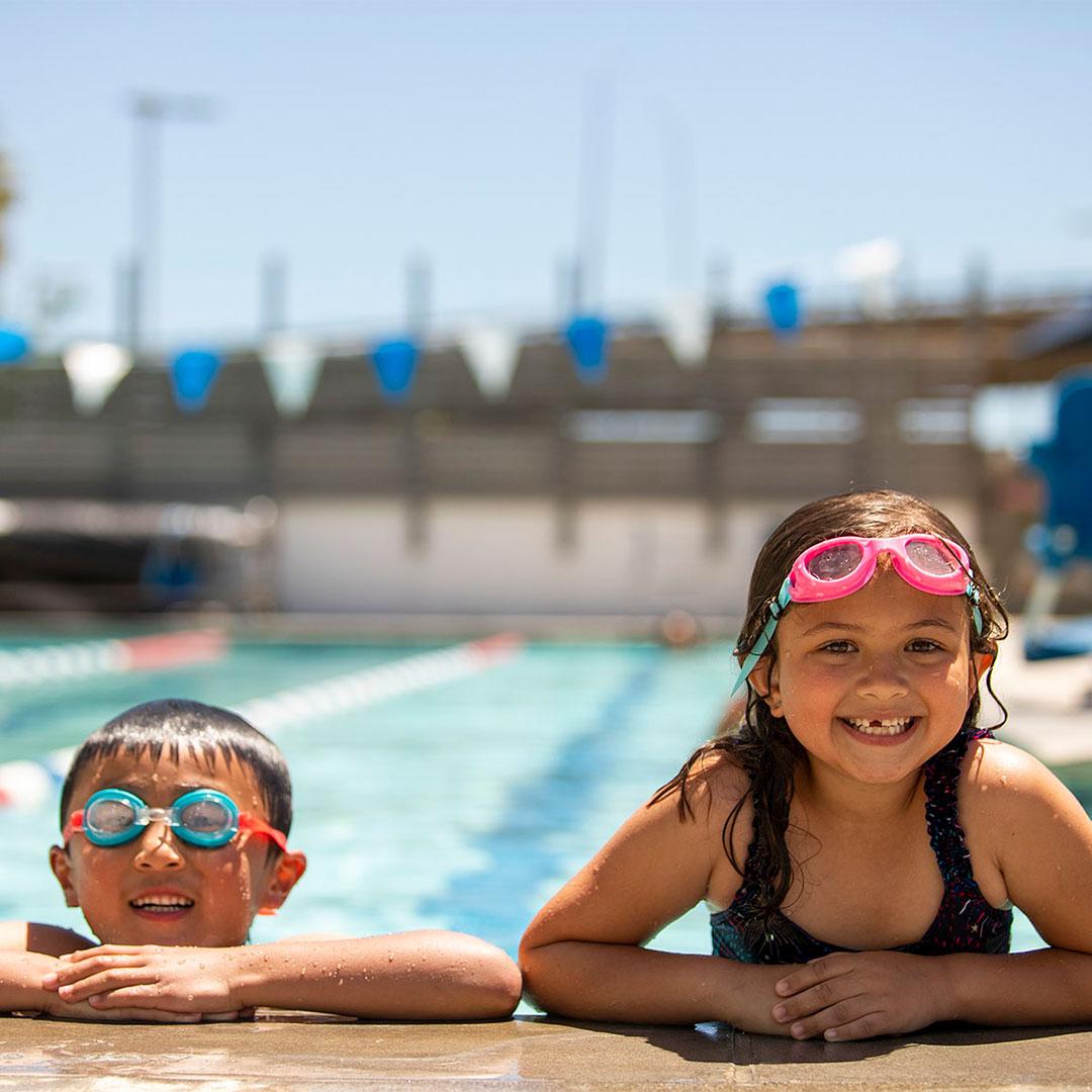 Two children on the edge of a pool